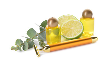 Facial massage tool with essential oil on white background