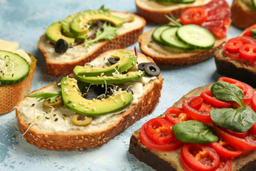 Fresh tasty bruschettas on color background