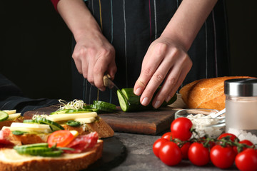 Woman preparing tasty bruschettas