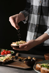 Woman preparing tasty bruschettas