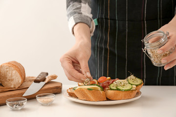 Woman preparing tasty bruschettas