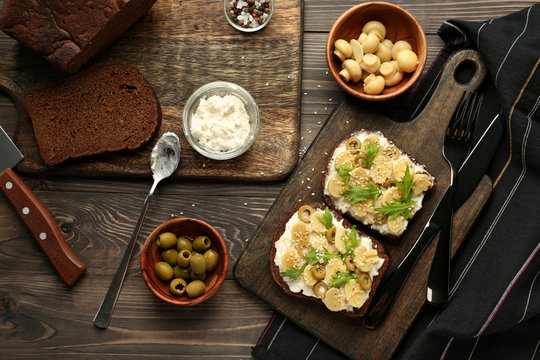Fresh tasty bruschettas on wooden table