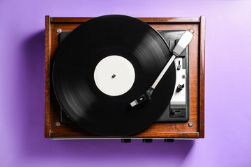 Obraz premium Record player with vinyl disc on color background