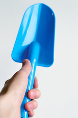 blue scoop in hand on white background