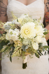 Non-traditional bride holding floral bouquet
