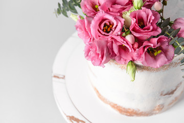 Sweet cake with floral decor on light background, closeup