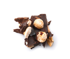 Pieces of tasty dark chocolate with nuts on white background
