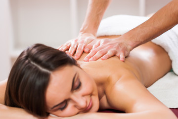 Fototapeta na wymiar Young woman is enjoying massage on spa treatment. 
