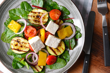 Healthy salad with feta cheese on plate