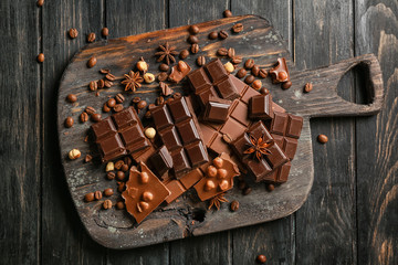 Sweet tasty chocolate on wooden board