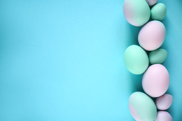 Painted Easter eggs on color background
