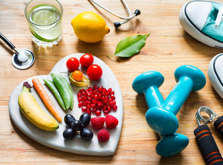 Healthy lifestyle concept with food in heart diet  fitness sport and medicine concept