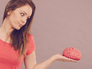 Woman holding brain thinking