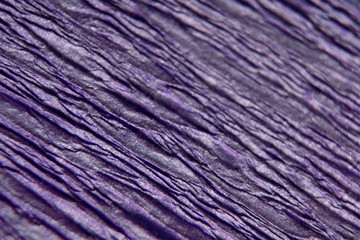 Wrinkled and crumpled blue paper as background or texture. Macro, close-up of paper.