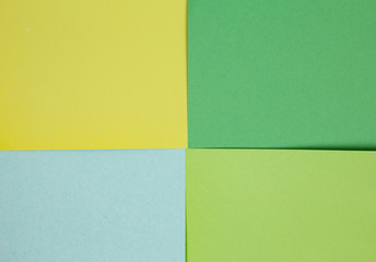 sheets of colored paper. Many colored sheets of paper are laid out in the harsh composition. background of colored paper.