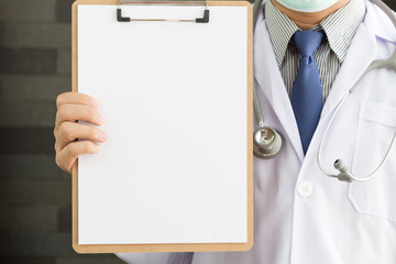 Close-up of a male doctor with lab coat and holding blank clipboard