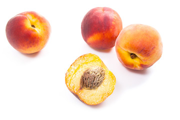 Naklejka na ściany i meble Group of ripe peach fruit and a half isolated on white background.