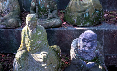 Stone statue of a seated Buddhist monks close-up