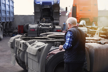 a mechanic conducts a technical inspection of the truck