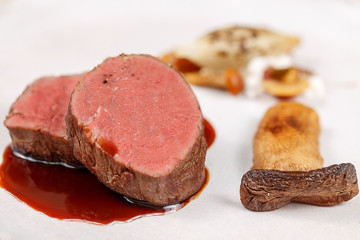 beef filet medium rare sereved with onion and musgroom with a demiglase sauce