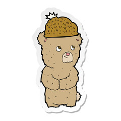 sticker of a cartoon bear in hat