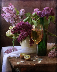 Still-life with a lilac in a white jug