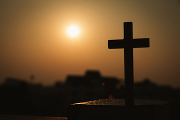  silhouette of cross and bible with the sunset as background, christian concept, spirituality and religion