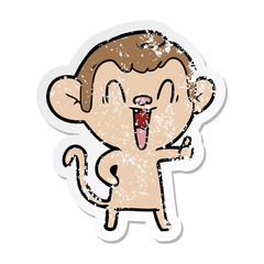 distressed sticker of a cartoon laughing monkey