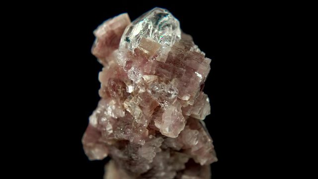 Seamlessly rotating a mineral (Topaz on Lepidolite) in front of black background