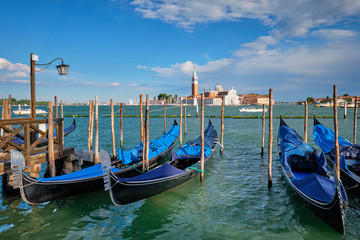 Gondolas and in lagoon of Venice by San Marco square. Venice, Italy