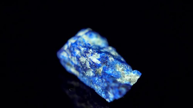 Seamlessly rotating a blue mineral (Lapis Lazuli) in front of black background