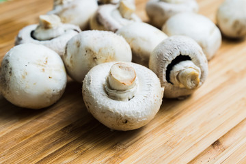 white mushrooms on wooden board