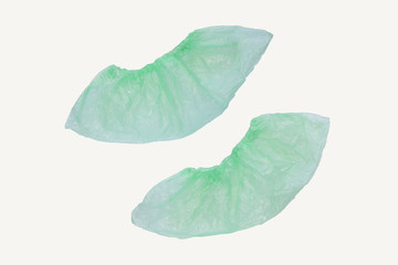 Fototapeta premium Two medical green shoe covers overshoes isolated on white background. Catalog top view