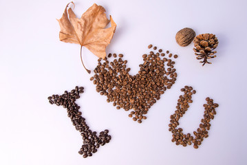 Coffee bean heart decoration on white background