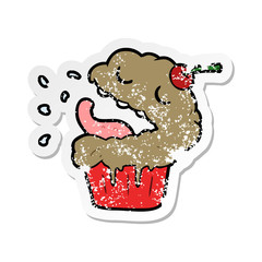 distressed sticker of a cartoon cupcake