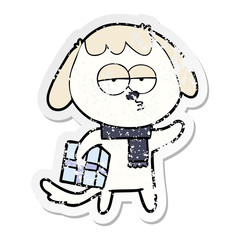 distressed sticker of a cartoon bored dog with christmas present