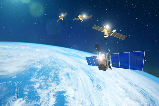 Group of satellites in a row orbiting the earth, for communication and monitoring systems. Elements of this image furnished by NASA.