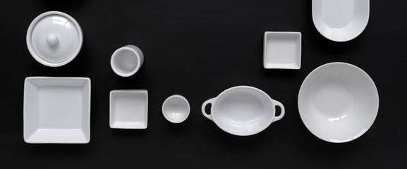 white, modern tableware in various designs on a black background