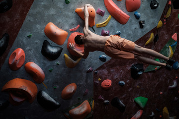 Athletic man practicing in a bouldering gym © Nejron Photo