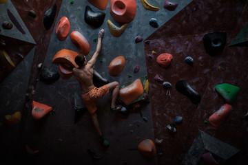 Athletic man practicing in a bouldering gym