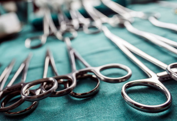 Some scissors for surgery in an operating theater, conceptual image, horizontal composition
