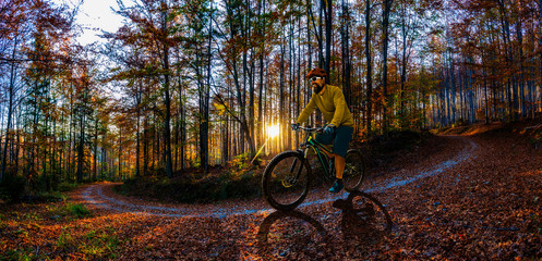 Single mountain bike rider on electric bike, e-mountainbike rides mountain trail. Man riding on bike in Beskidy mountains landscape. Cycling e-mtb enduro trail track. Outdoor sport activity.