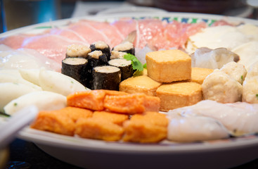 Assort many of Suki Hotpot Shabu set on hot pot, pork, fish, mussel, squid, egg, shrimp, fish ball ,Seaweed ,fish tofu ,woo