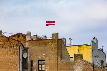 Latvian flag on a top of the building in Riga