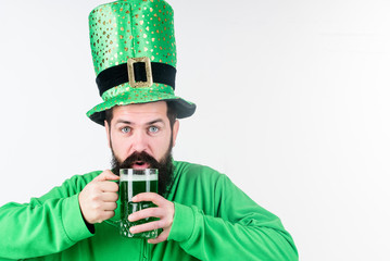 Colored green beer. Green beer part of celebration. Irish pub. Alcohol consumption integral part saint patricks day. Irish culture. Man bearded hipster funny hat drink pint beer. Cheers concept