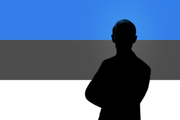 Silhouette of businessman on the background of the Estonian flag.