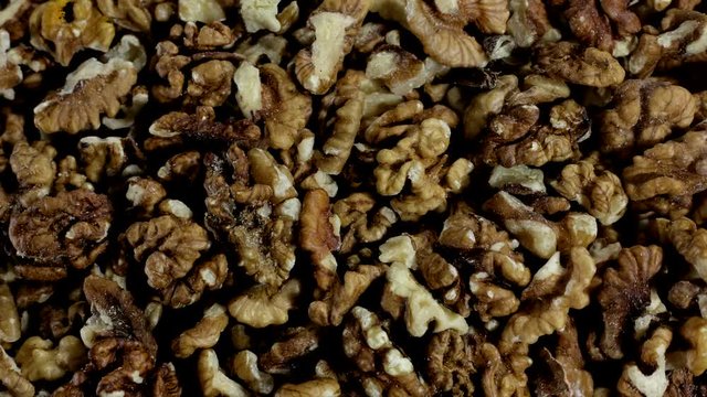 Pile of shelled wallnuts in stop motion. Top view. Background