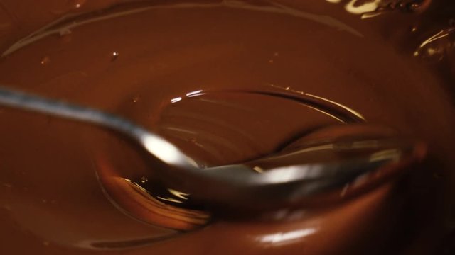 Spoon stir in melted dark premium chocolate