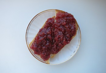 two pieces of wheat bread with raspberry jam