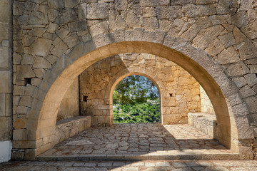 Fototapeta na wymiar Stone arches in monastery garden, Arkadi monastery in Crete